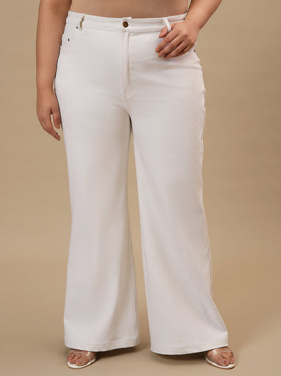 Plus-size woman in angled front view wearing White Plus Size Bootcut Jeans with structured fit and flared leg design