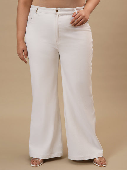Plus-size woman in angled front view wearing White Plus Size Bootcut Jeans with structured fit and flared leg design