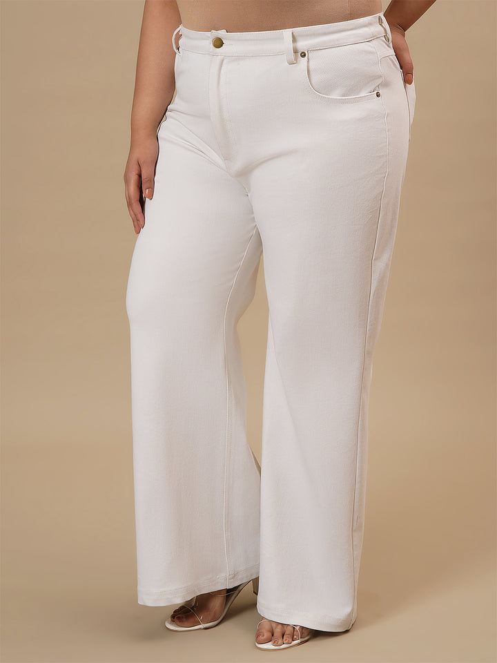 Plus-size woman in left side view wearing White Plus Size Bootcut Jeans with mid-rise waist and flared hem