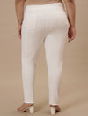 Plus-size woman in back side view wearing White Plus Size Jeggings featuring smooth back and snug fit