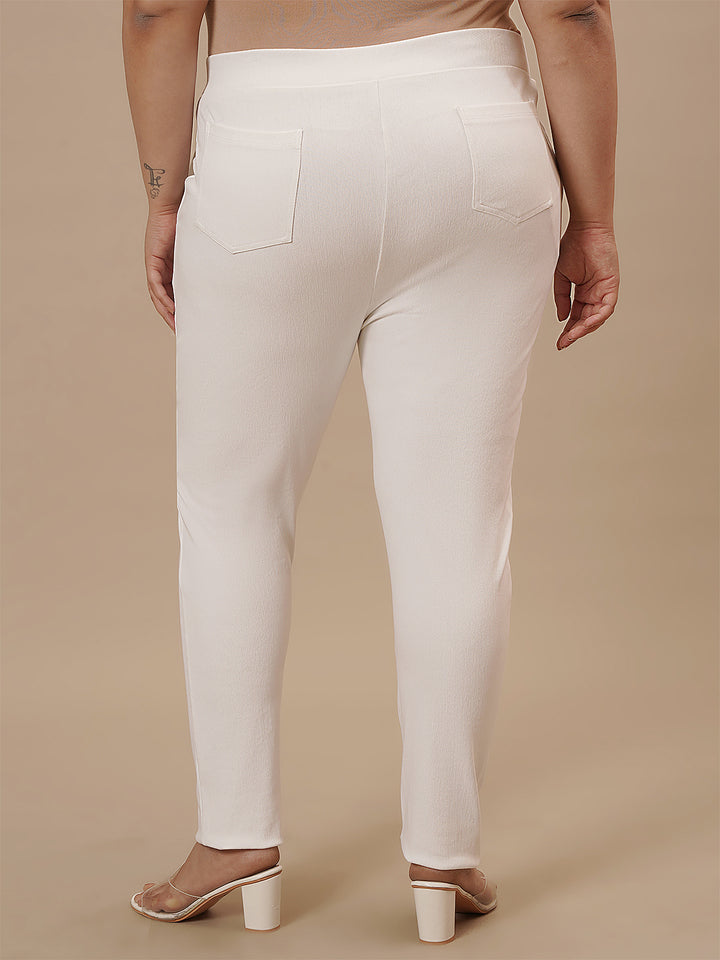 Plus-size woman in back side view wearing White Plus Size Jeggings featuring smooth back and snug fit