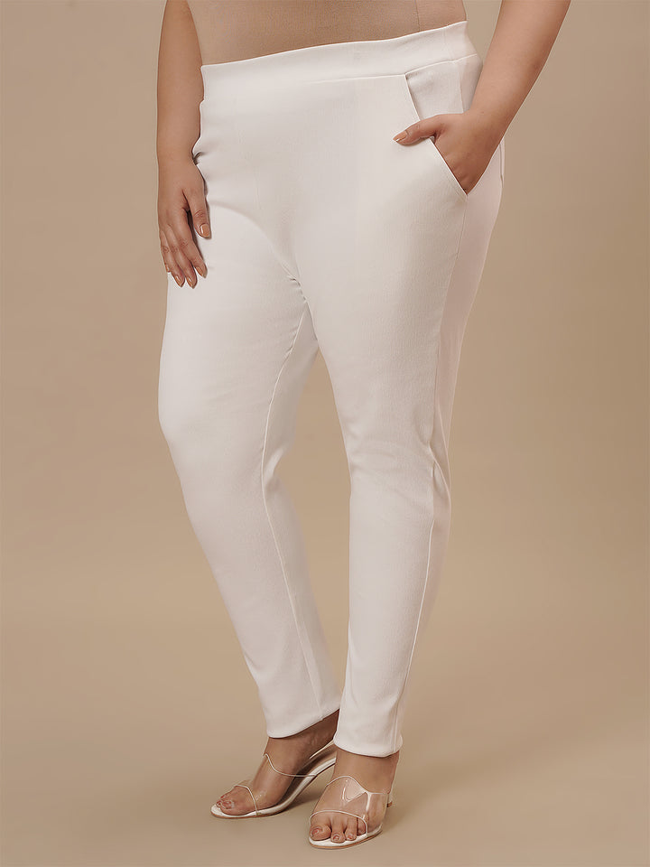 Plus-size woman in front left angle view wearing White Plus Size Jeggings with body-hugging fit and high waist
