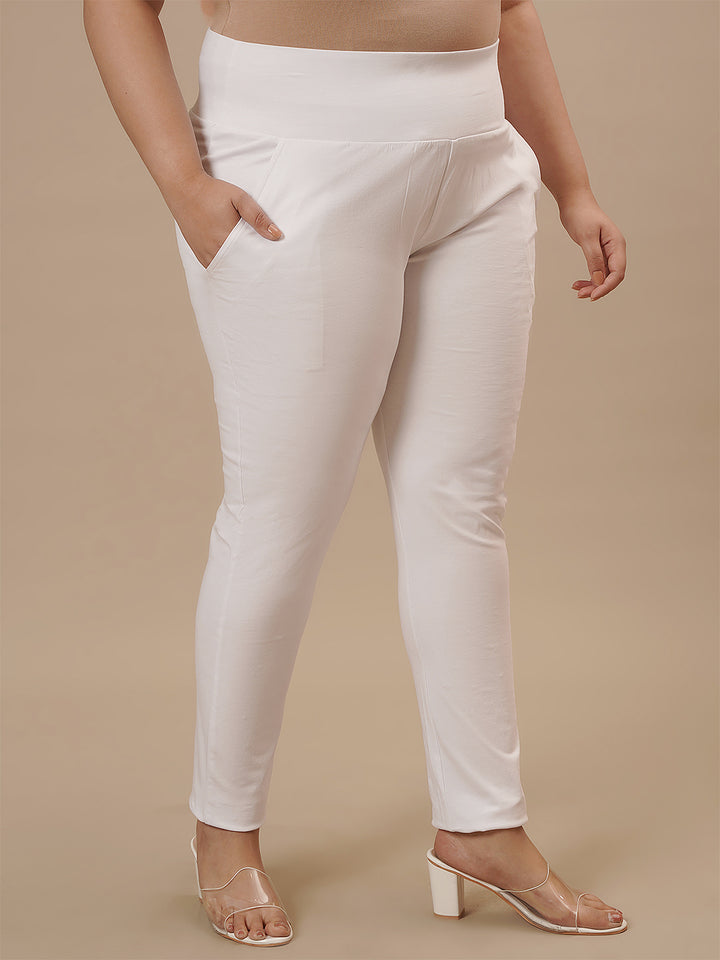 Plus-size woman in right side view wearing White Plus Size Leggings With Pockets with snug fit and side pocket detail