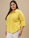 Plus-size woman in left side view wearing Yellow Plus Size Cotton Shirt with full sleeves and comfortable fit