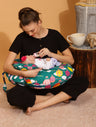 new mom feeding baby using breastfeeding pillow