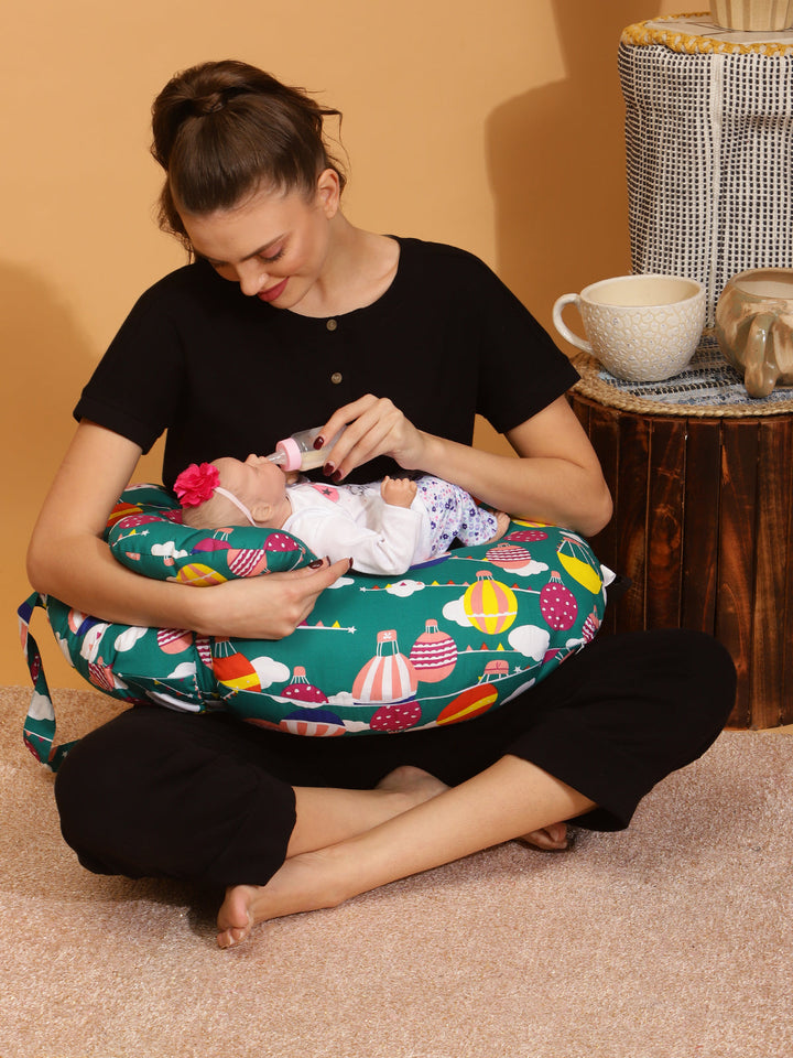 new mom feeding baby using breastfeeding pillow