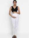 Pregnant woman wearing Wobbly Walk White Maternity Leggings, gently holding her belly