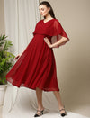 Side profile showing elasticated empire waist of Wobbly Walk Red Cape Maternity Dress