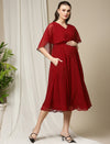 Side profile showing one hand in pocket of Wobbly Walk Red Cape Maternity Dress